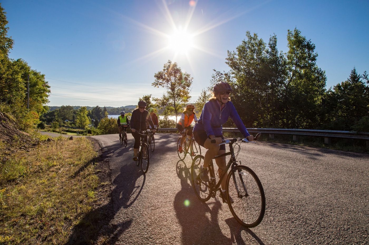 Three people biking in East Ferris on a sunny day.