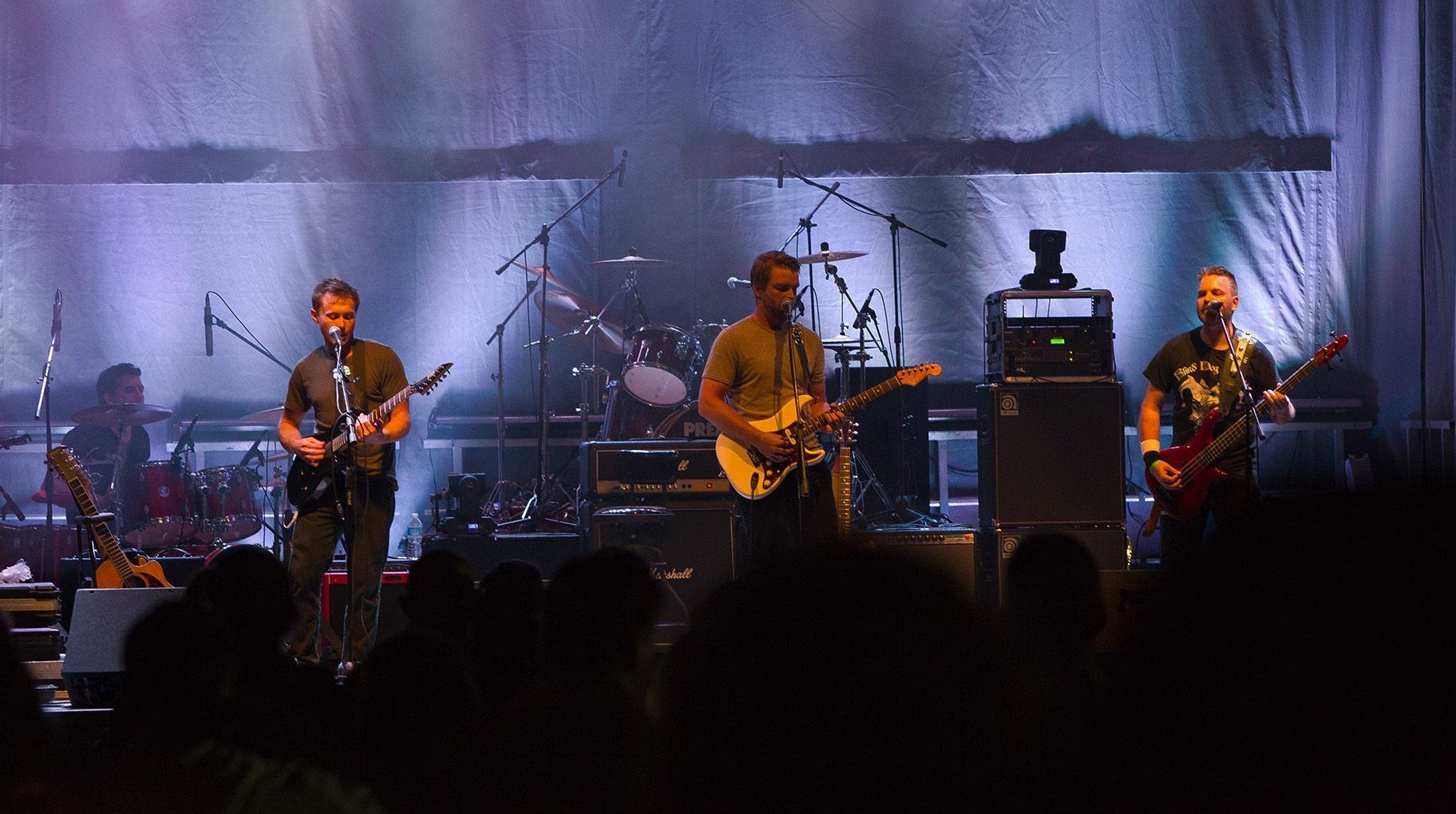 A band performing a concert on stage in Timmins, Ontario.